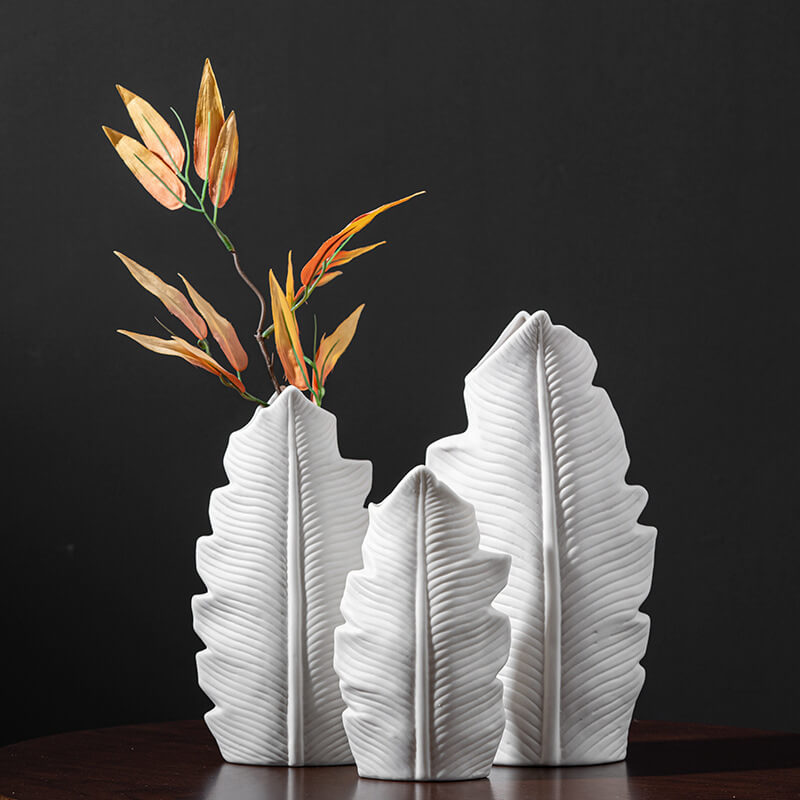 Front view of Nordic ceramic leaf-shaped flower pot with plant