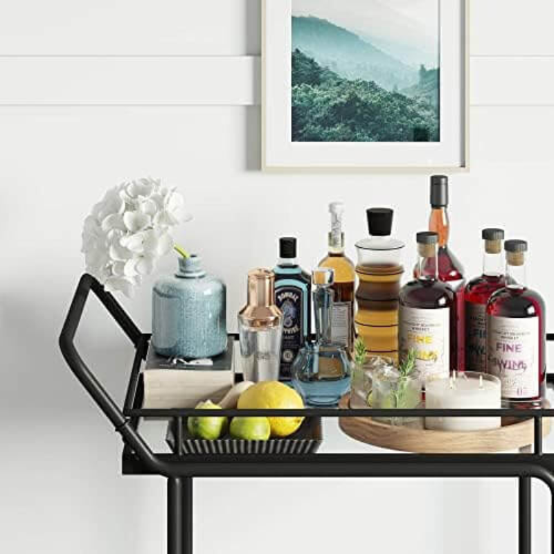 Sleek metal rolling bar cart with glass shelves in a stylish kitchen setting