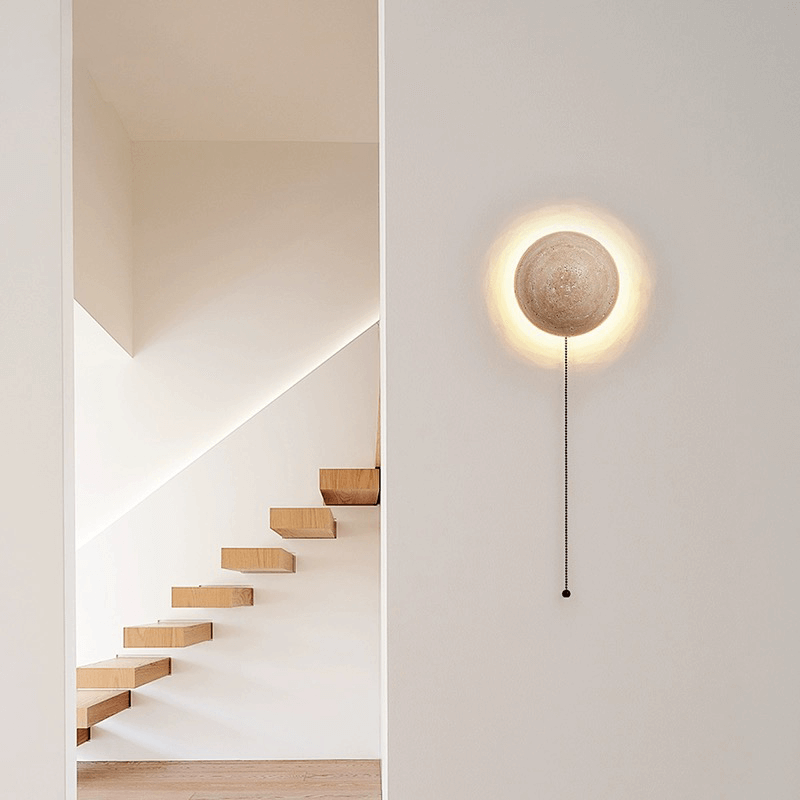 Close-up view of the travertine stone texture of the LED wall light, highlighting its unique character.