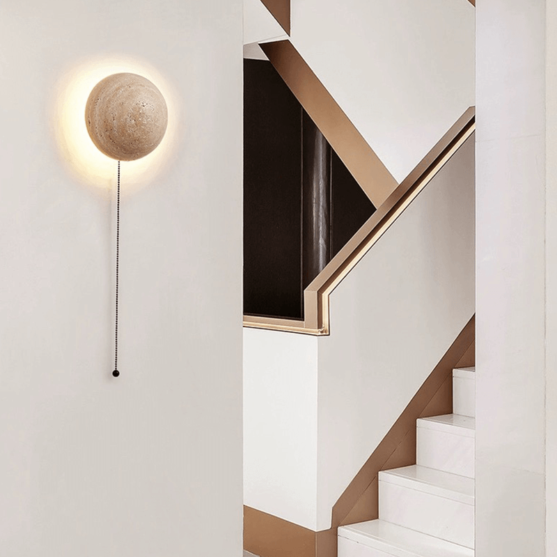 Close-up view of the travertine stone texture of the LED wall light, highlighting its unique character.