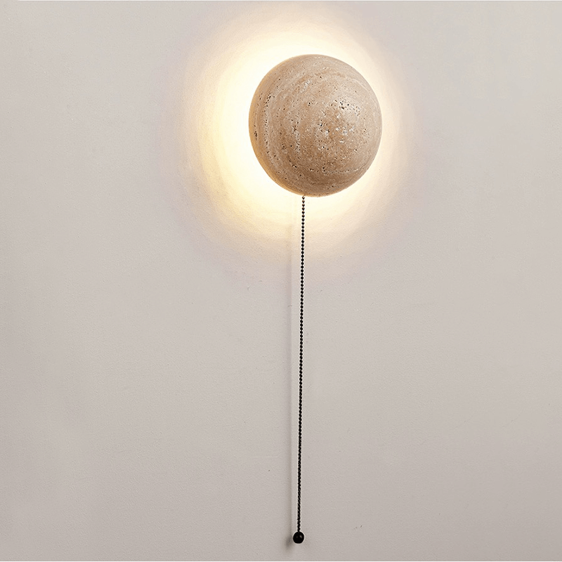 The modern design of the cave stone LED wall light illuminating a stylish hallway.