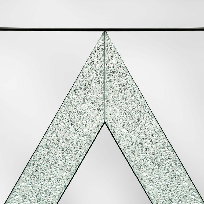 Close-up of the mirrored door of the entryway cabinet reflecting light beautifully