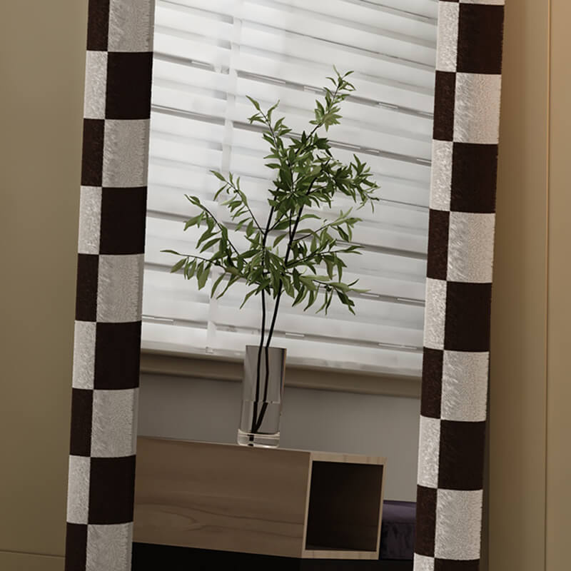 Close-up of the mirrors matte black frame and stylish white pattern backing.