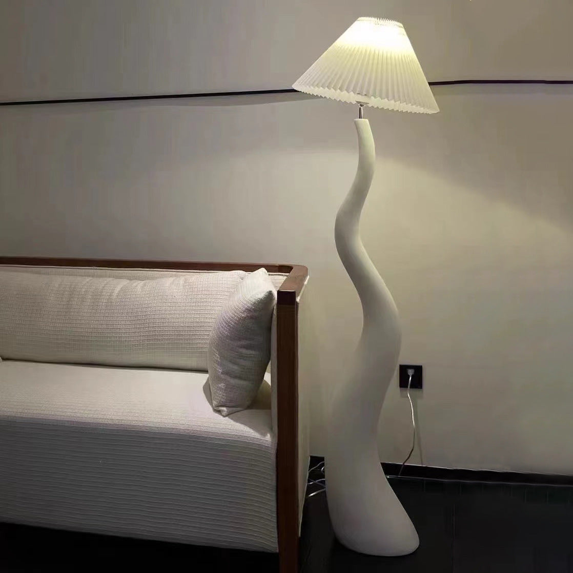 The foot switch of the Elegant Curved Mushroom Floor Lamp in a stylish bedroom, providing easy access.