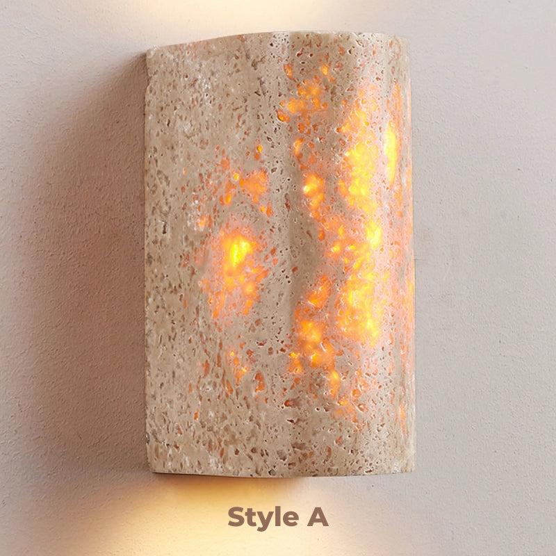 The elegant wall sconce lit up in a cozy living room setting, adding a touch of sophistication to the ambiance.