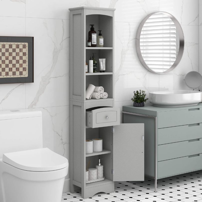 Front view of the tall grey cabinet with drawer, styled in a contemporary living room setting.