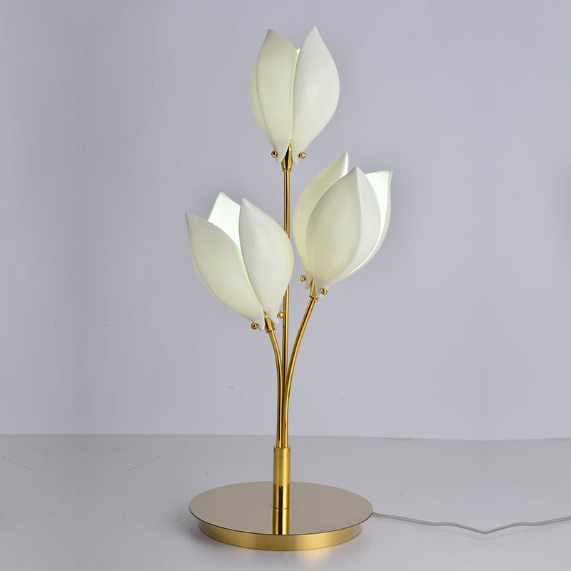 Elegant ceramic magnolia flower lamp on a bedside table with soft lighting