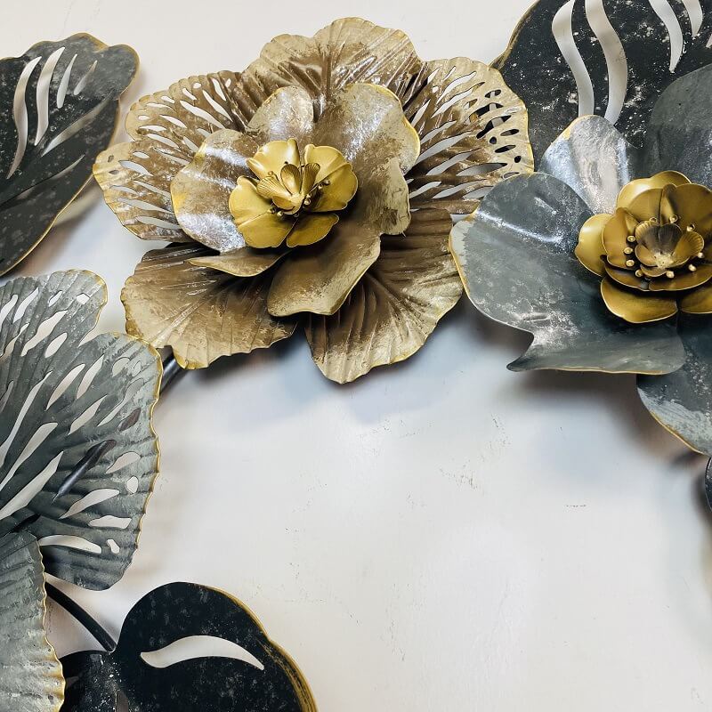 Close-up of decorative wall hanging featuring floral design against a neutral background.