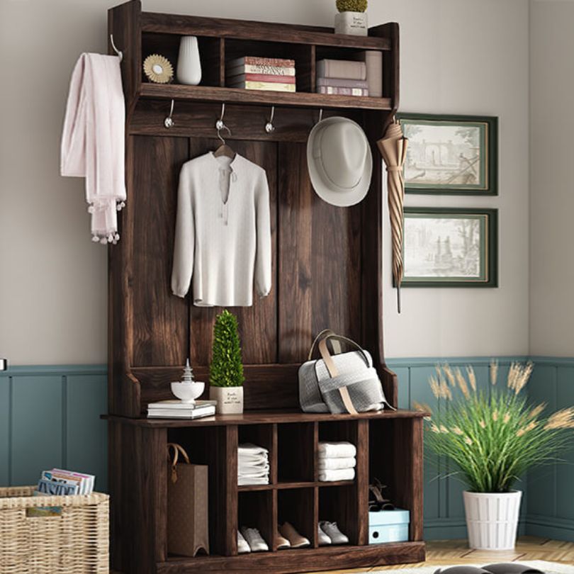 Elegant entryway hall tree with storage bench and hooks from the front angle.