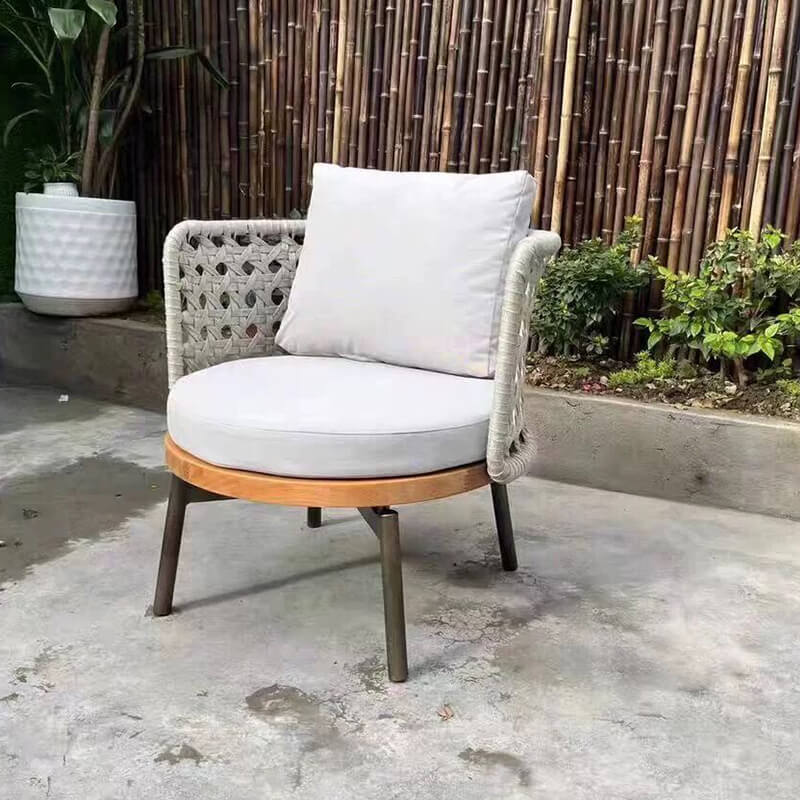 Serenity Teak Outdoor Conversational Set from the side, showcasing the Ecru and Dark Brown woven design.