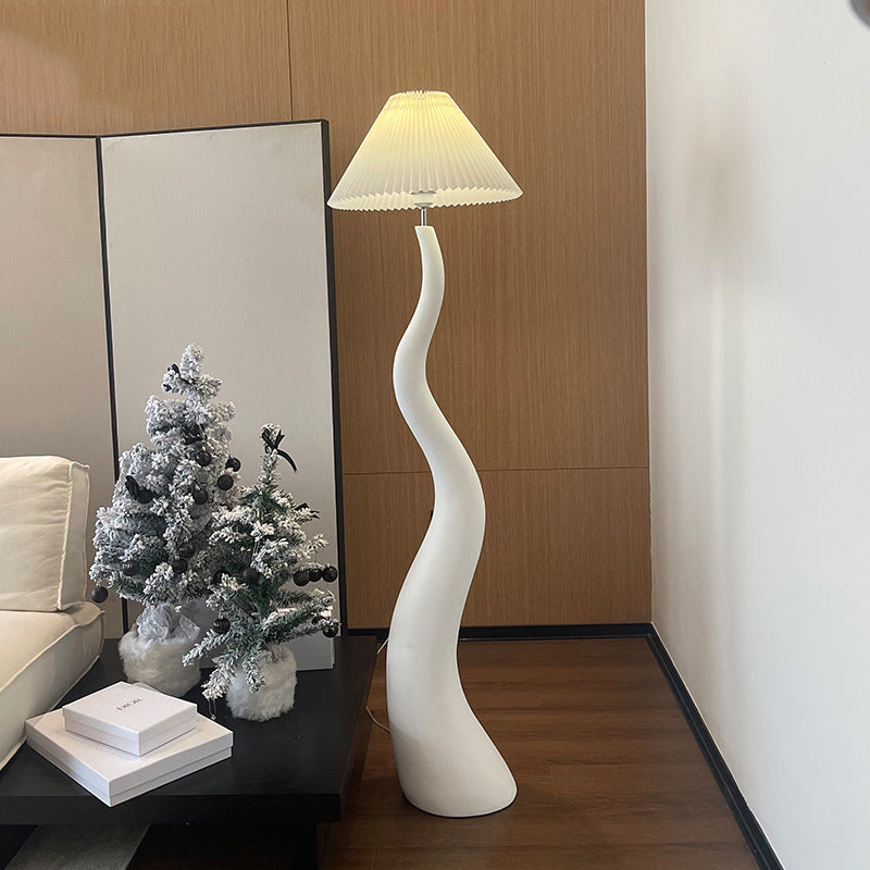 Close-up of the handcrafted resin body of the floor lamp, highlighting its unique organic shapes.