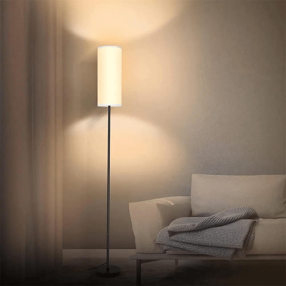Close-up of the linen lampshade on a sleek floor lamp, showcasing its fabric texture.