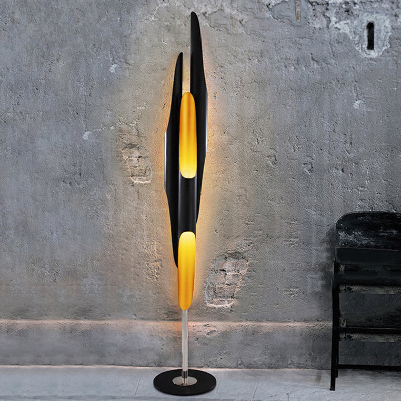 Elegant Golden Black Aluminum Tube Floor Lamp in a cozy living room setting.