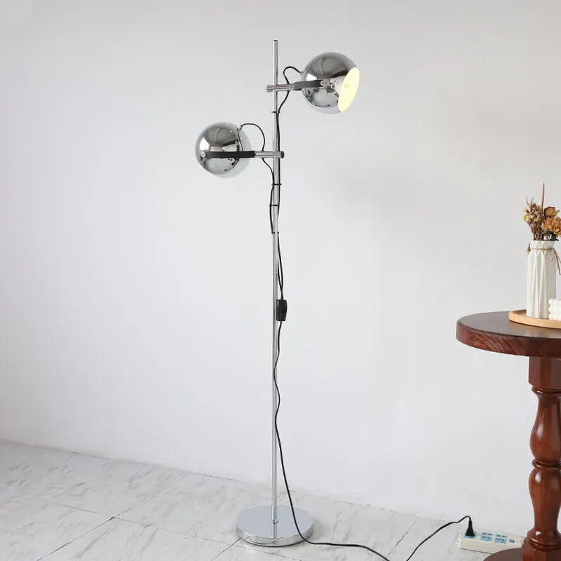 Close-up of the chrome finish and iron shade on the Bauhaus floor lamp.