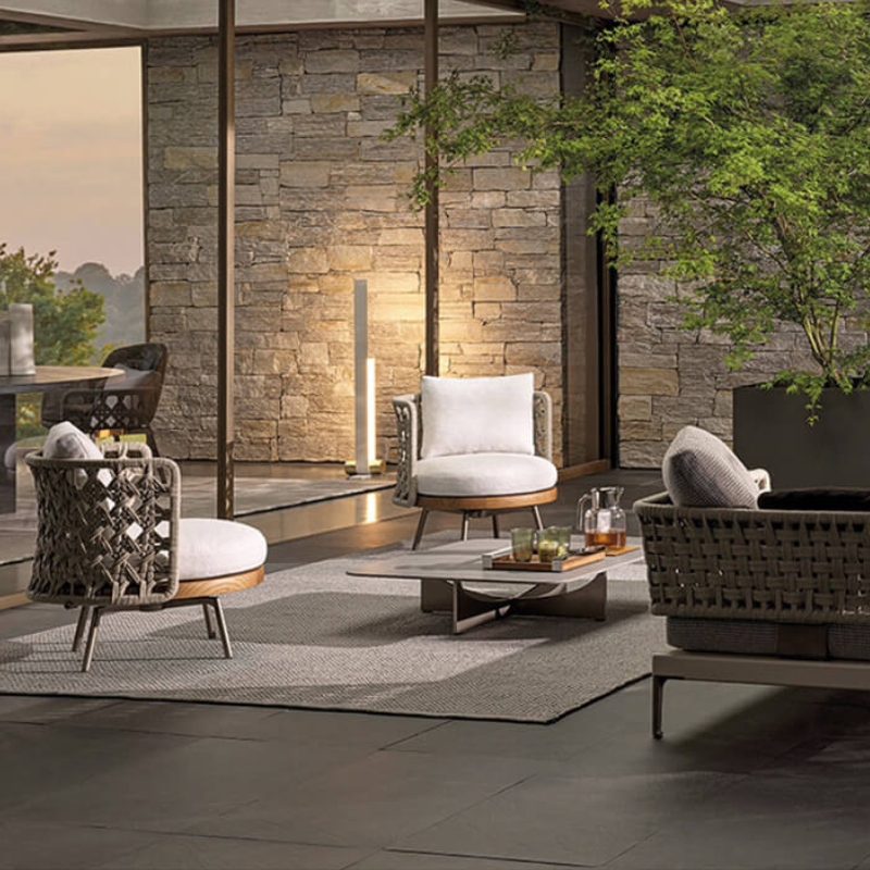 Serenity Teak Outdoor Conversational Set from the side, showcasing the Ecru and Dark Brown woven design.