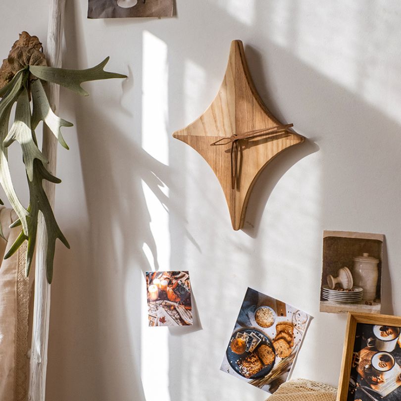 Side angle of the wooden star wall clock, highlighting the textured finish.