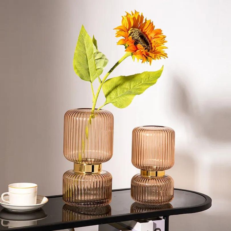 Elegant vertical grain glass flower vase showcasing gold and purple colors.