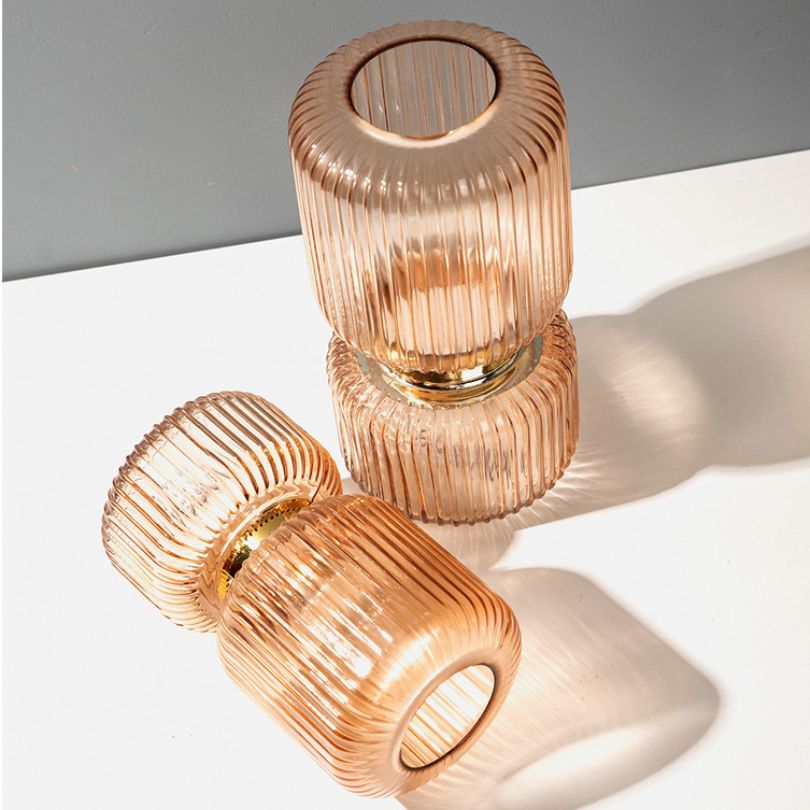 Elegant vertical grain glass flower vase showcasing gold and purple colors.