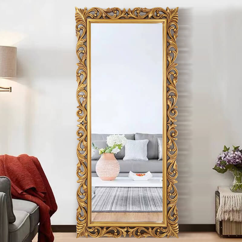 Elegant Victorian full-length vanity mirror displaying its antique gold frame in a stylish bedroom setting.