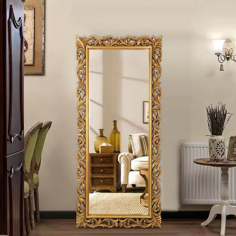 Elegant Victorian full-length vanity mirror displaying its antique gold frame in a stylish bedroom setting.