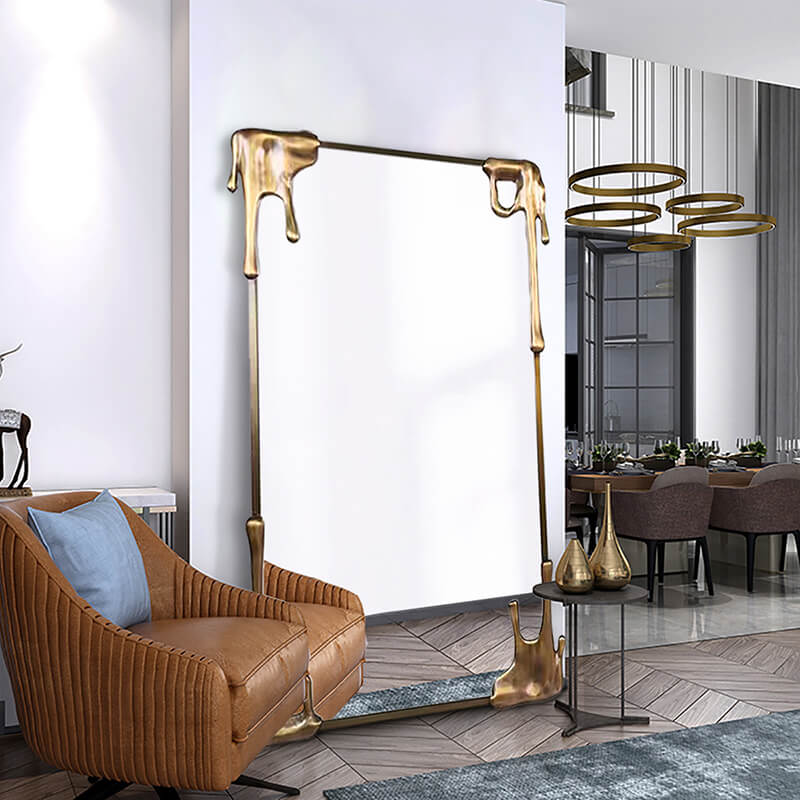 Close-up of the bronze frame detailing on a full-length mirror, highlighting its craftsmanship.