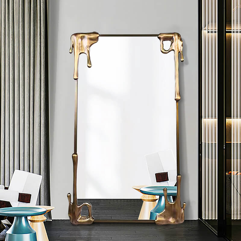 Elegant vintage bronze frame mirror showcasing its full-length design in a bright bedroom setting.