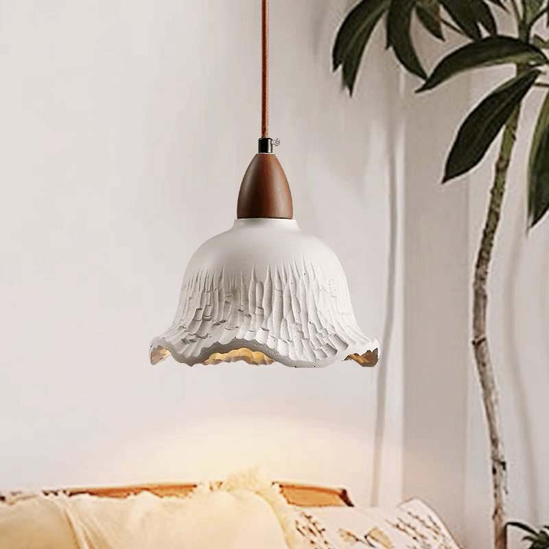 Vintage concrete hanging lamp showcasing its elegant flower shade design from a side angle.