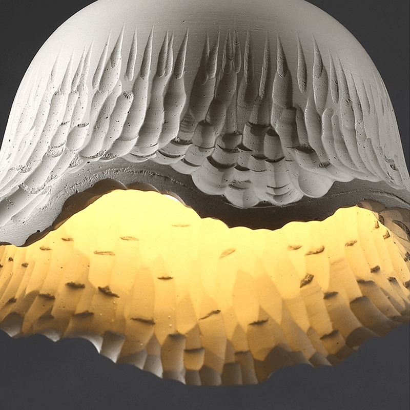 Close-up of the concrete lamps intricate flower shade, emphasizing its vintage charm and quality materials.