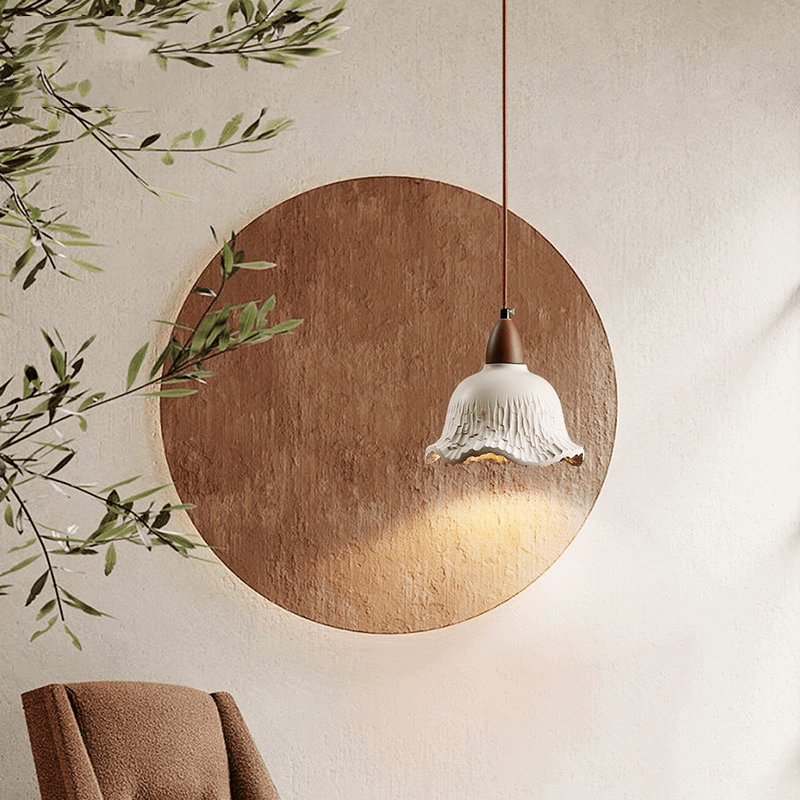 Close-up of the concrete lamps intricate flower shade, emphasizing its vintage charm and quality materials.