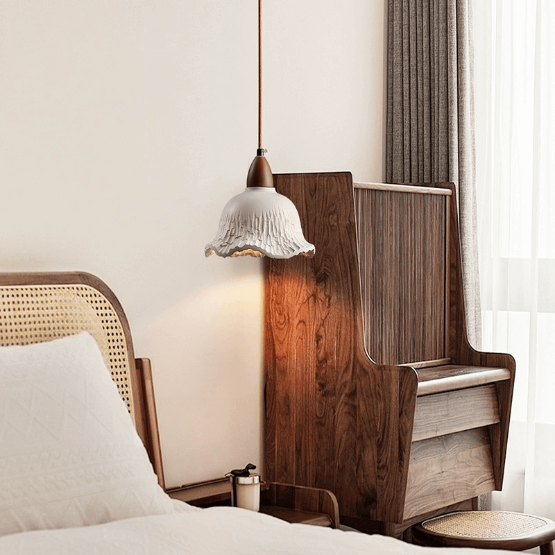 Vintage concrete hanging lamp showcasing its elegant flower shade design from a side angle.