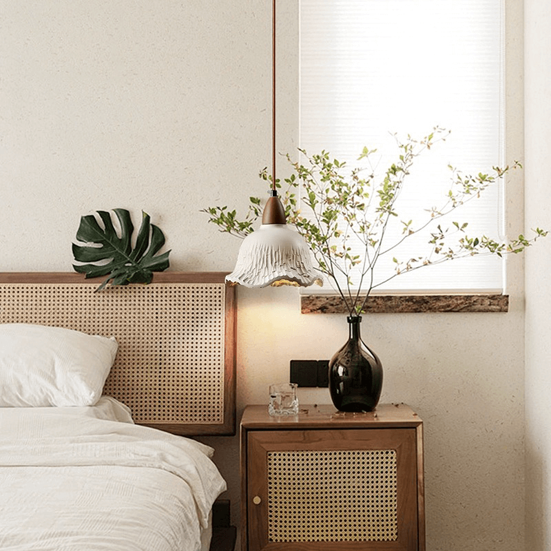 Close-up of the concrete lamps intricate flower shade, emphasizing its vintage charm and quality materials.