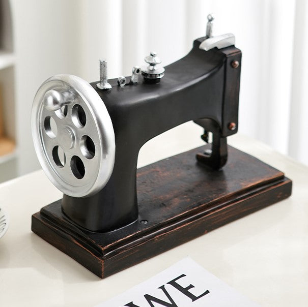 Side view of charming vintage resin sewing machine decor showcasing intricate details.