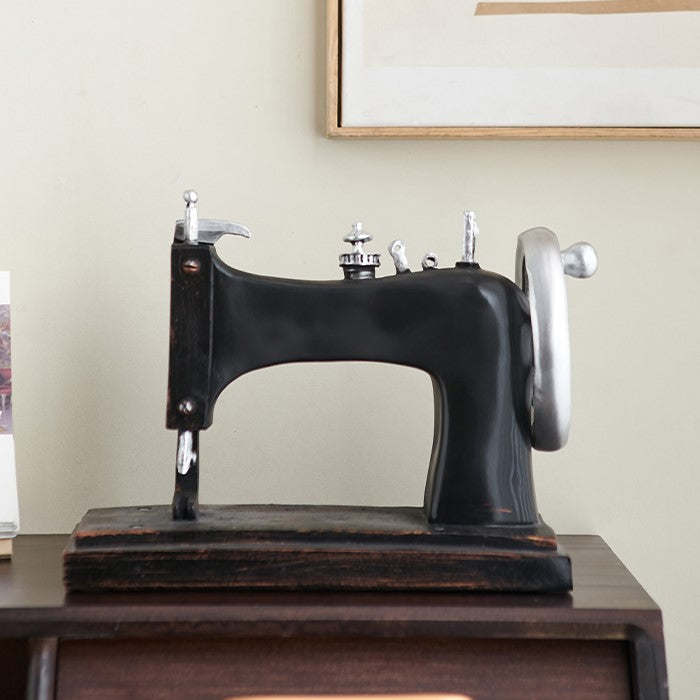Close-up of resin sewing machine decor highlighting its craftsmanship.
