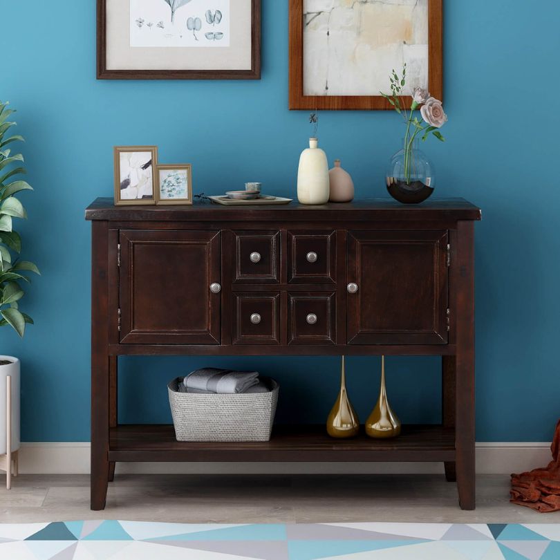 Elegant vintage buffet table showcasing intricate woodwork and dark brown finish.