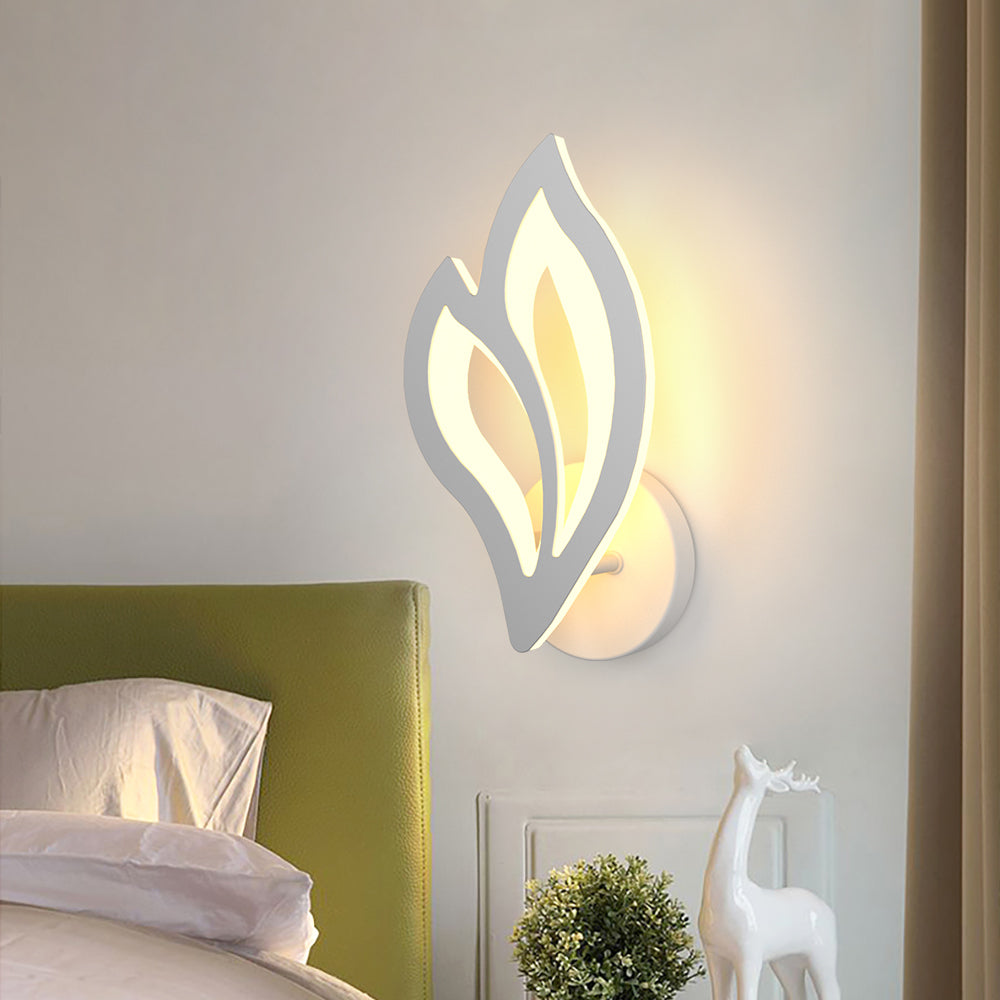 Elegant white leaf LED wall sconce showcased in a cozy cafe setting.