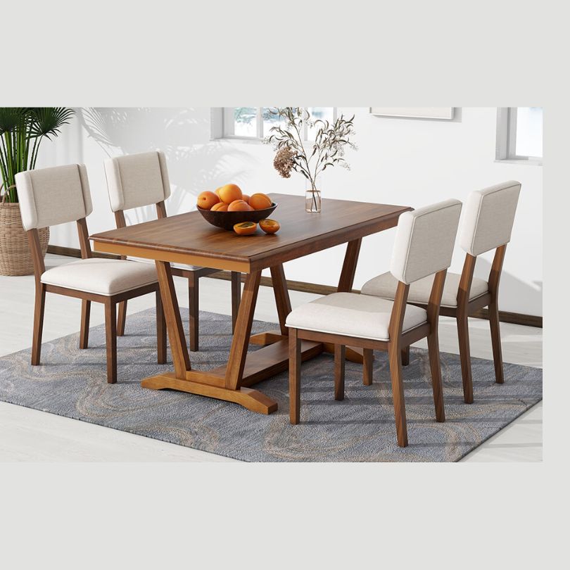 Elegant walnut dining table set showcasing the trestle base and four chairs from an angle.