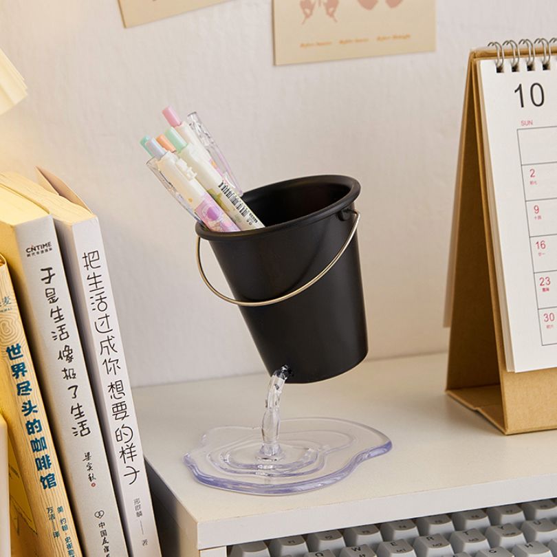 Black Water Bucket Design Pen Holder filled with colorful writing instruments, ideal for home office use.
