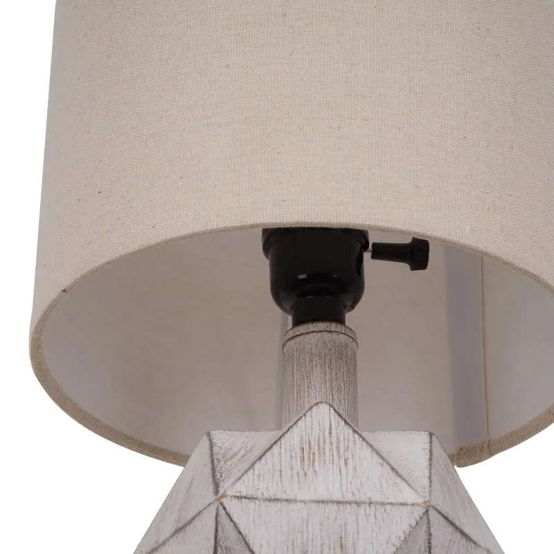 Close-up of the faceted faux wood texture of the modern lamp.