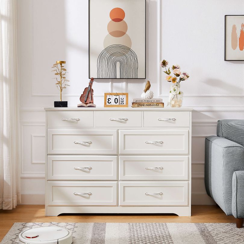 Front angle of white dresser showcasing 9 spacious drawers and antique handles