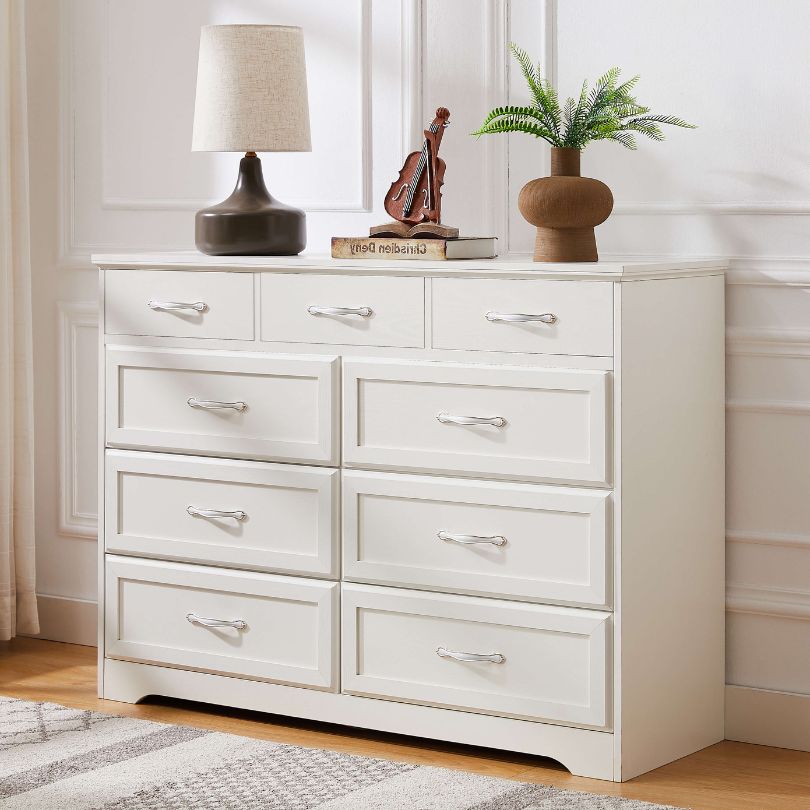 Side view of dresser styled in a classic bedroom with neutral décor