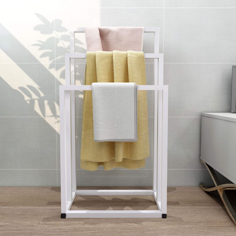 Freestanding 3-tier towel rack showcasing towels in a stylish bathroom setting.