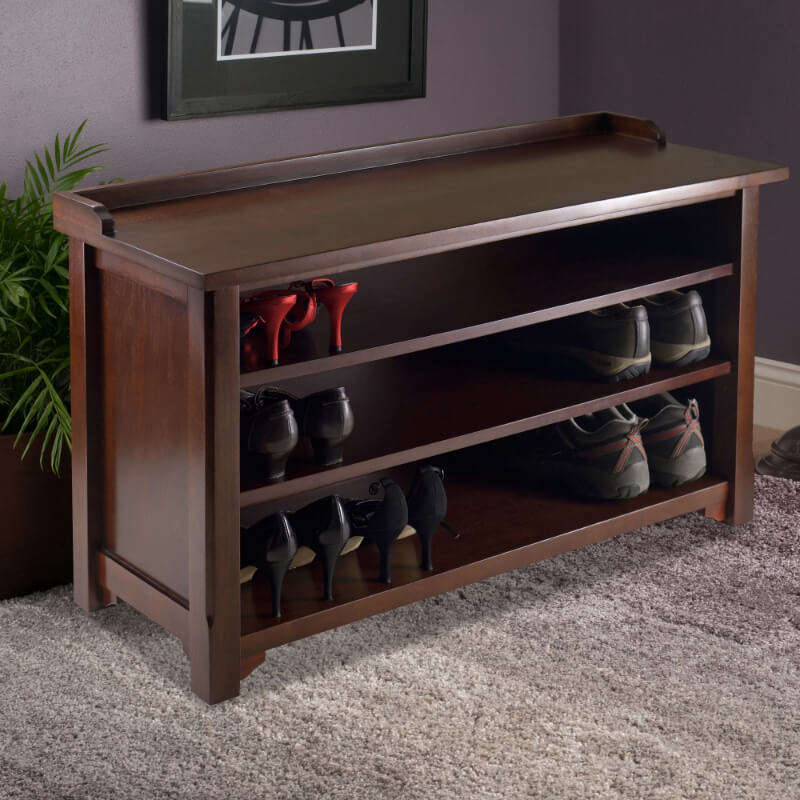 Dayton wooden storage bench in foyer with shoes neatly organized on shelves.
