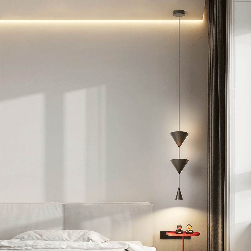 Front view of modern cone-shaped LED pendant light in a dining room setting.