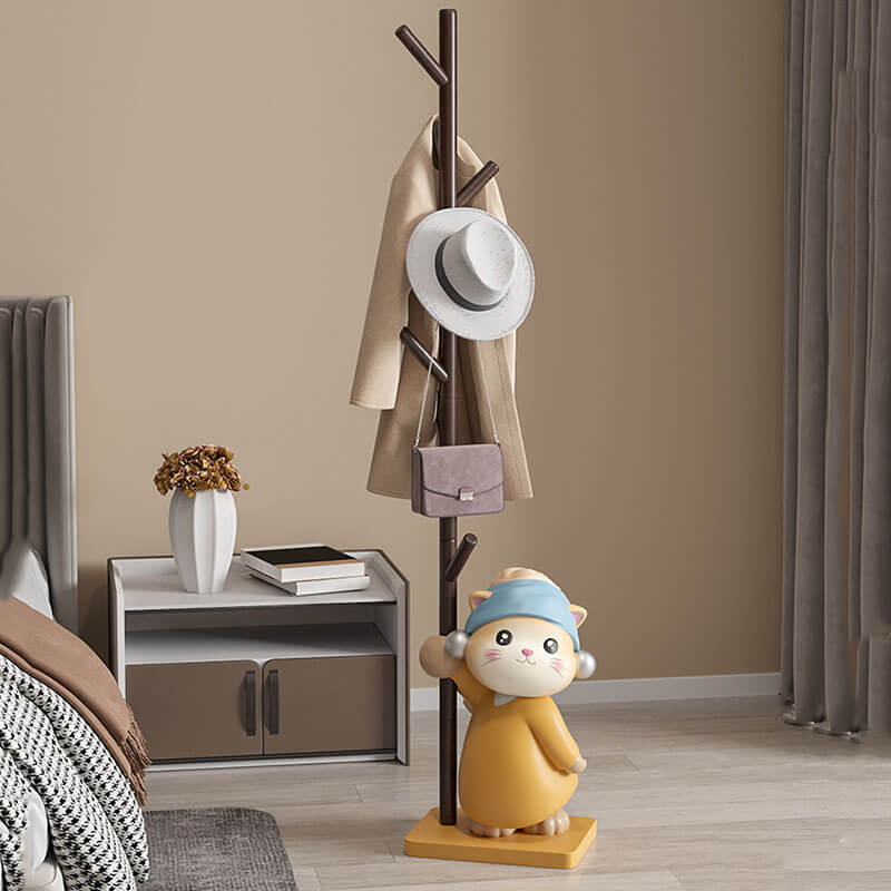 Front view of the Scandinavian Cat Figurine Wood Coat Rack in a bright entryway, displaying its natural wood finish and eight branches.
