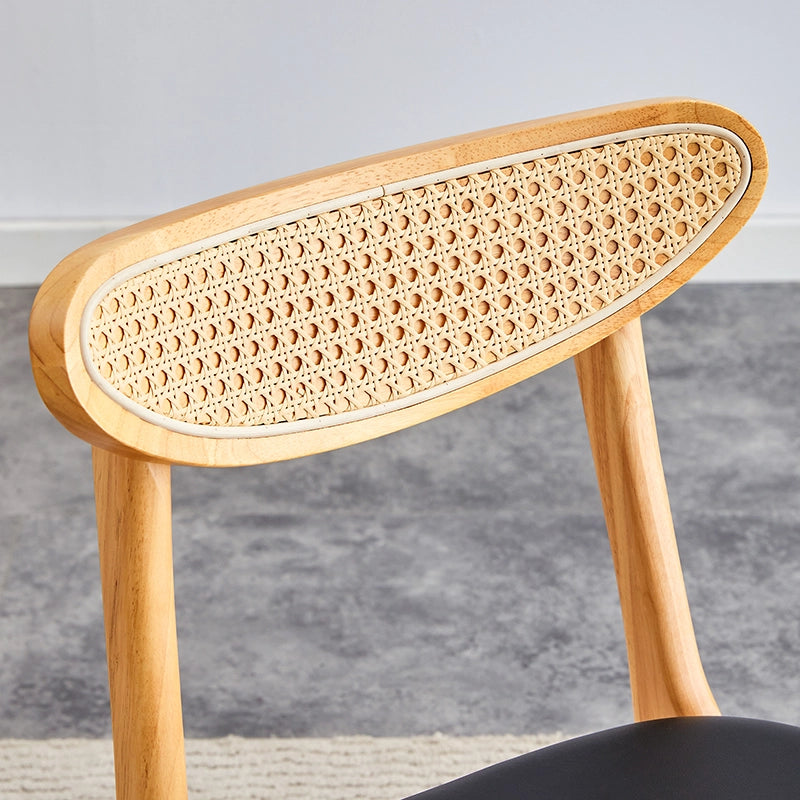 Close-up of the plush cushioning on the upholstered chair with a curved backrest.