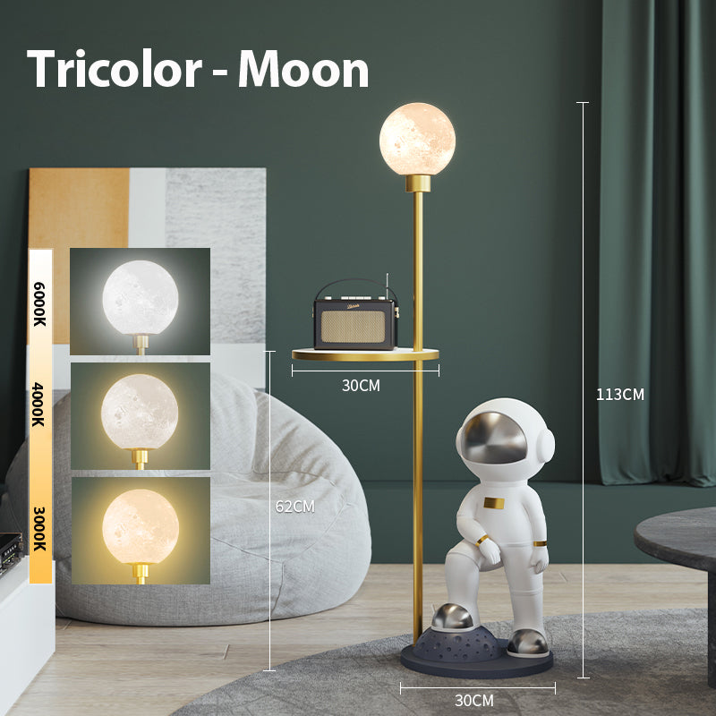 View of the astronaut lamp with integrated round table, placed next to a sofa.