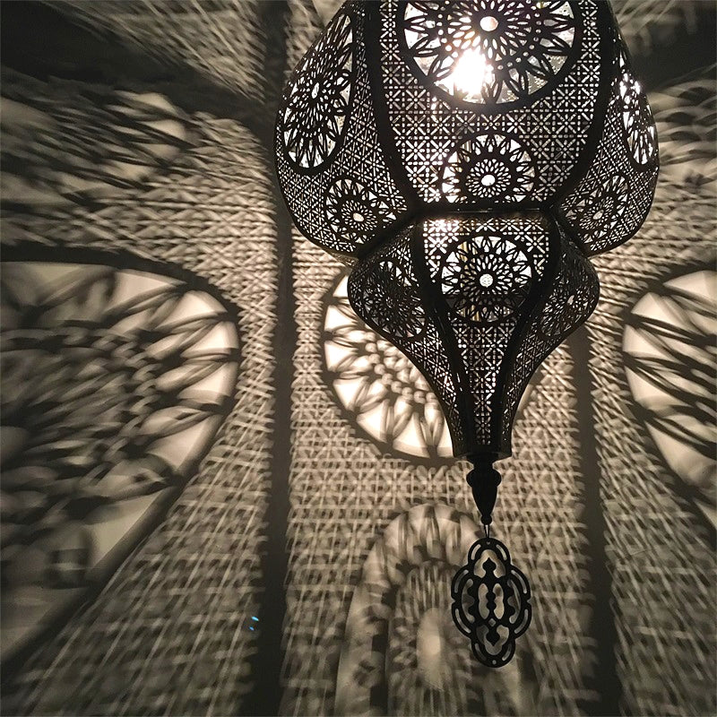 Moroccan vintage light fixture illuminating a cozy patio space.