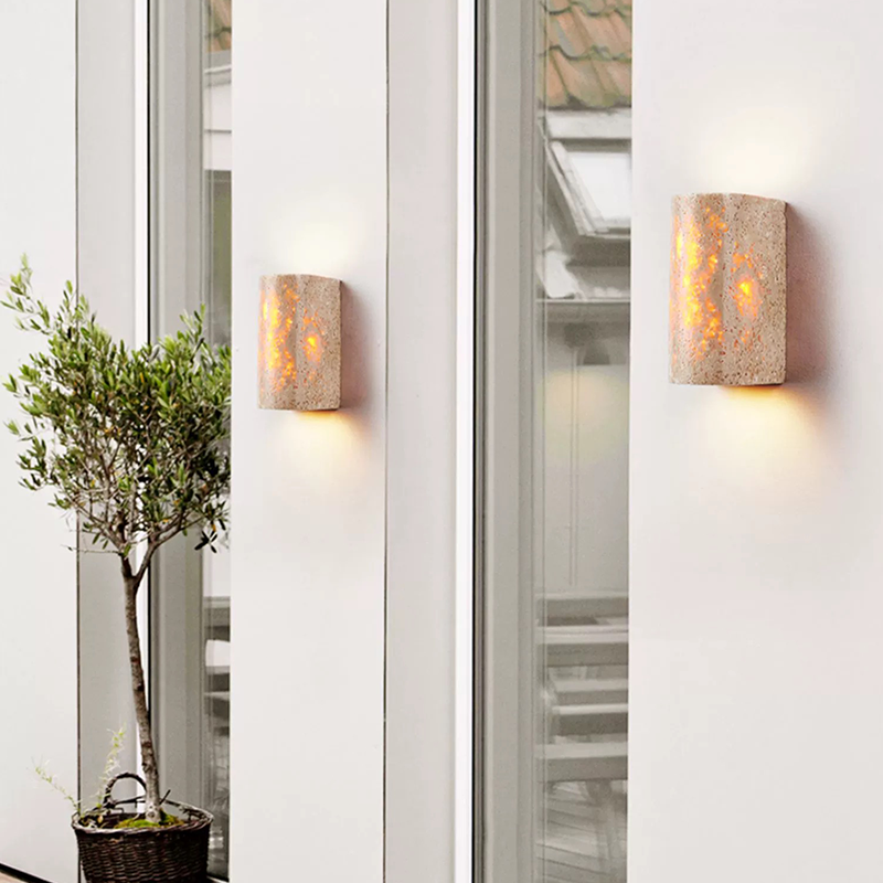 Elegant Yellow Travertine Wall Sconce Lamp showcasing its unique patterns and warm glow from an angle.