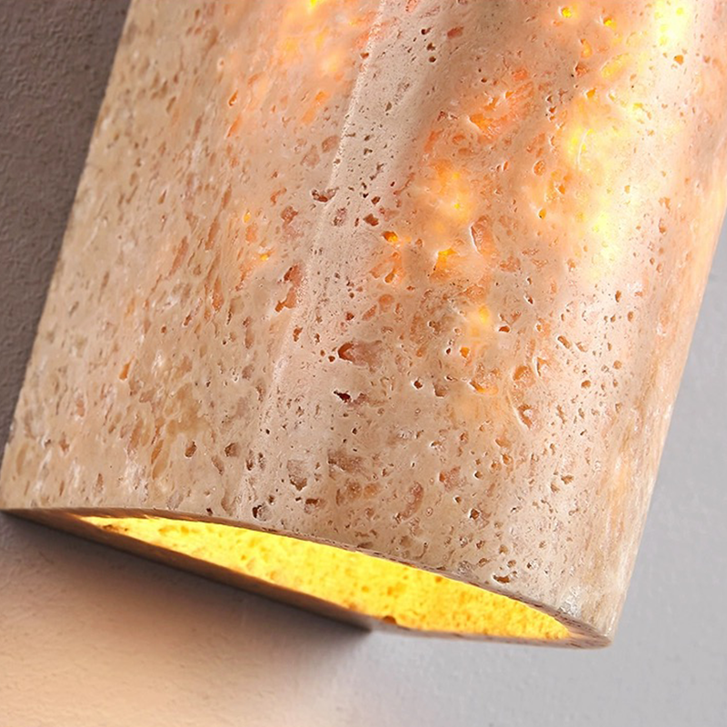 Close-up of the half-cylinder shape of the yellow travertine lamp, highlighting the texture and craftsmanship.