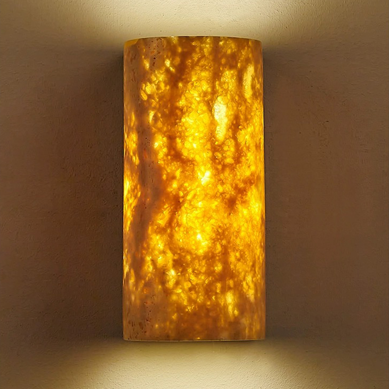 The elegant wall sconce lit up in a cozy living room setting, adding a touch of sophistication to the ambiance.